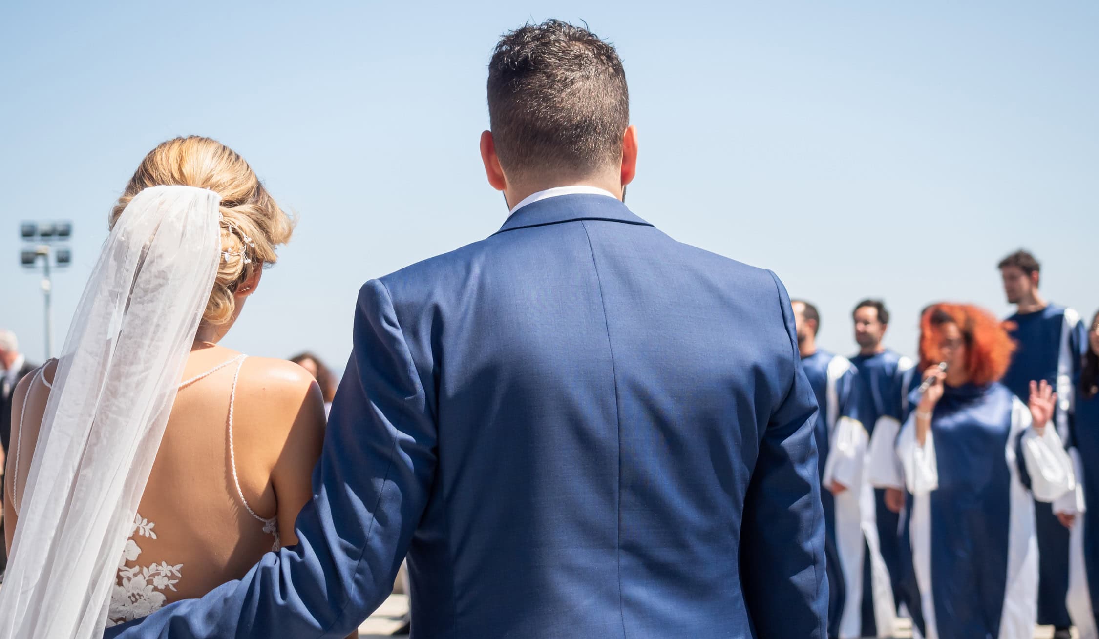 Newlyweds watching the gospel concert welcoming them as they leave the church - ParisOuestWedding - Jérôme Correia